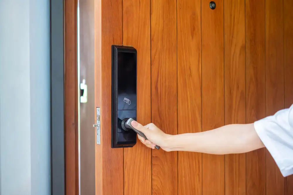 man holding handle smart digital door lock while open close door technology electrical lifestyle concepts - Wireless vs Wired Home Automation: Which is Right for Your Newcastle Home?